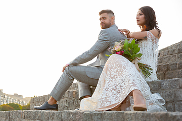 Image showing Caucasian romantic young couple celebrating their marriage in city