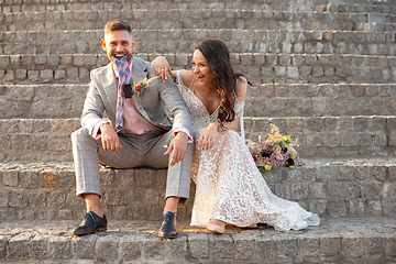 Image showing Caucasian romantic young couple celebrating their marriage in city