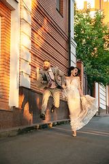 Image showing Caucasian romantic young couple celebrating their marriage in city