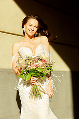 Image showing Caucasian romantic young groom celebrating his marriage in city