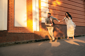 Image showing Caucasian romantic young couple celebrating their marriage in city