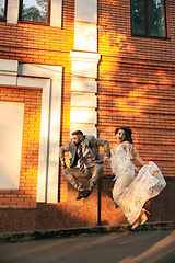 Image showing Caucasian romantic young couple celebrating their marriage in city