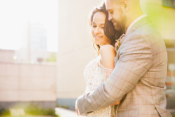 Image showing Caucasian romantic young couple celebrating their marriage in city