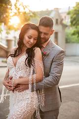 Image showing Caucasian romantic young couple celebrating their marriage in city