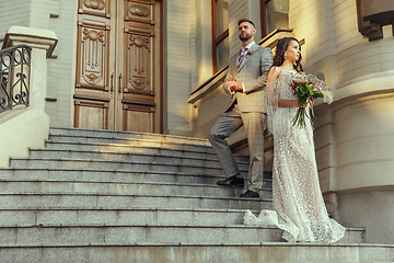 Image showing Caucasian romantic young couple celebrating their marriage in city