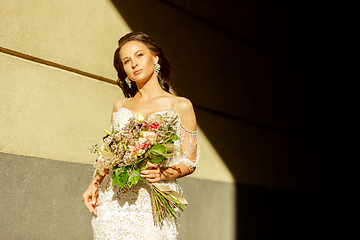 Image showing Caucasian romantic young groom celebrating his marriage in city