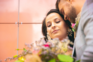 Image showing Caucasian romantic young couple celebrating their marriage in city