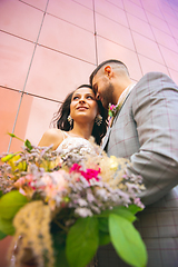 Image showing Caucasian romantic young couple celebrating their marriage in city