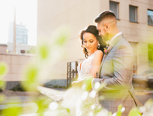 Image showing Caucasian romantic young couple celebrating their marriage in city