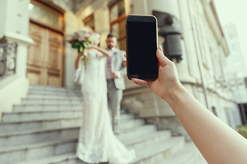 Image showing Caucasian romantic young bride celebrating his marriage in city