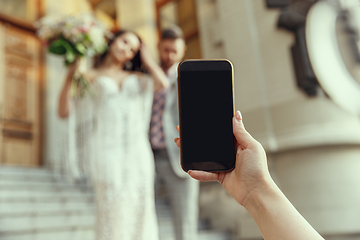 Image showing Caucasian romantic young bride celebrating his marriage in city