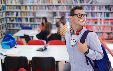 Image showing the student uses a notebook, latop and a school library