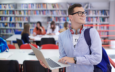 Image showing the student uses a notebook, latop and a school library