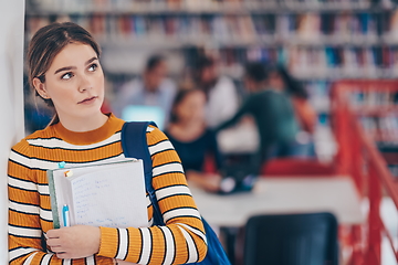 Image showing the student uses a notebook and a school library