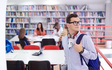 Image showing the student uses a notebook, latop and a school library