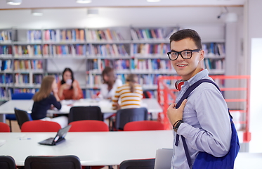 Image showing the student uses a notebook, latop and a school library