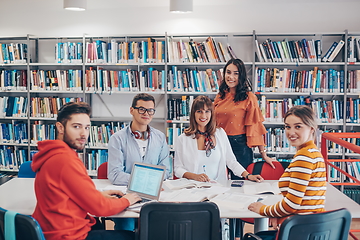 Image showing students group working on school project together on tablet computer at modern university