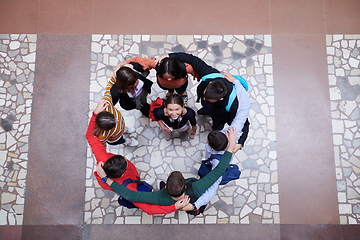 Image showing group of happy young people showing their unity.