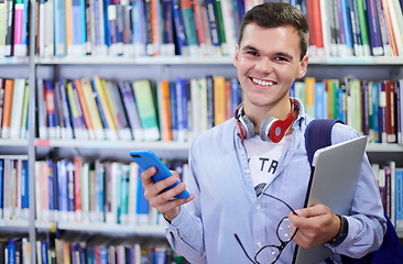 Image showing the student uses a notebook, latop and a school library