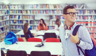 Image showing the student uses a notebook, latop and a school library