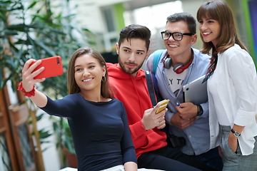 Image showing Group of multiethnic teenagers taking a selfie in school