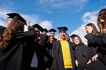 Image showing Group of diverse international graduating students celebrating