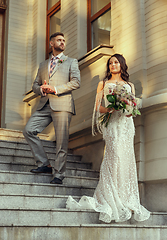 Image showing Caucasian romantic young couple celebrating their marriage in city