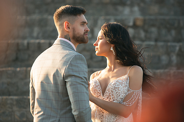 Image showing Caucasian romantic young couple celebrating their marriage in city