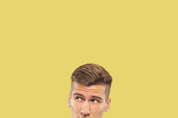 Image showing Caucasian young man\'s close up shot on yellow background