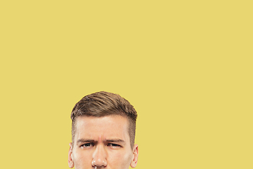 Image showing Caucasian young man\'s close up shot on yellow background