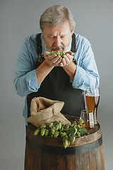 Image showing Confident senior man brewer with self crafted beer