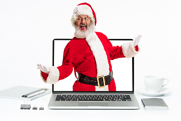 Image showing Happy Christmas Santa Claus greeting from the laptop screen on white background