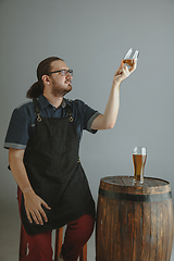 Image showing Confident young male brewer with self crafted beer