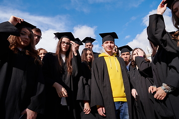 Image showing Group of diverse international graduating students celebrating