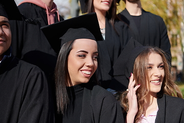 Image showing Group of diverse international graduating students celebrating