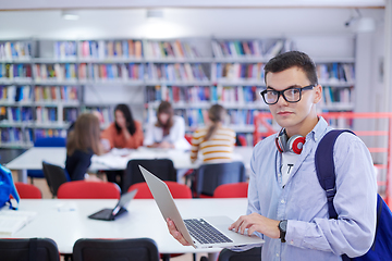 Image showing the student uses a notebook, latop and a school library