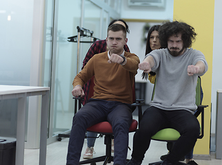Image showing Multiethnic startup group at office chair race