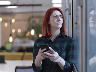 Image showing redhead business woman at office using smart phone