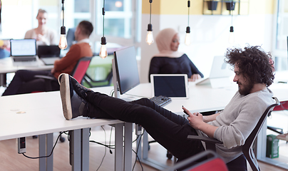 Image showing relaxed businessman working at modern office