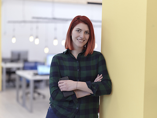 Image showing redhead business woman portrait in creative modern coworking startup open space office