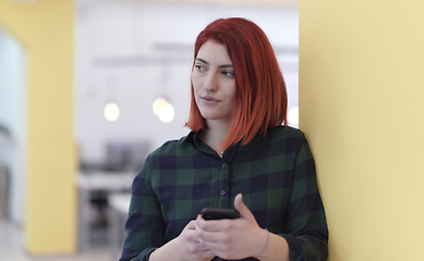 Image showing redhead business woman at office using smart phone