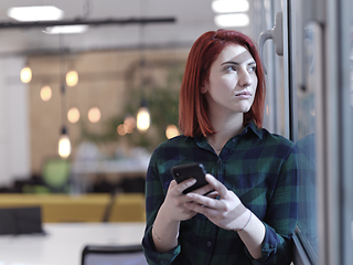 Image showing redhead business woman at office using smart phone