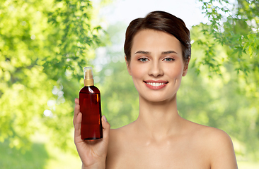 Image showing beautiful young woman with sun protective oil