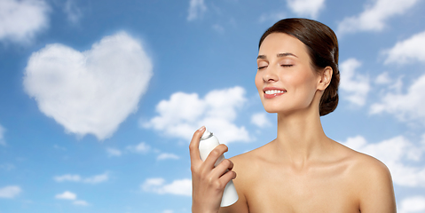 Image showing beautiful young woman with facial spray or mist