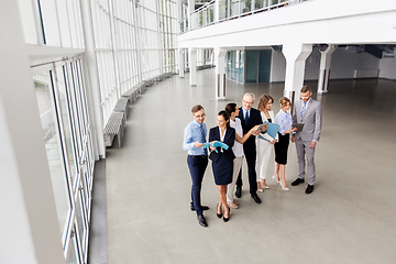 Image showing business team with tablet pc and folders at office