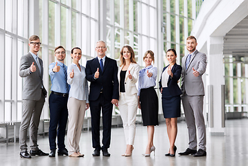 Image showing business people showing thumbs up at office