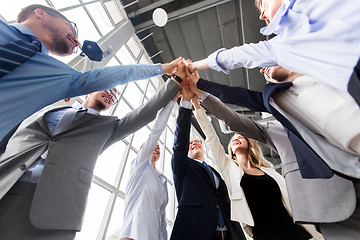 Image showing business people making high five at office