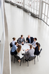 Image showing architects with laptop and blueprint at office