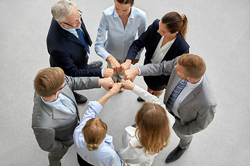 Image showing happy business people making fist bump