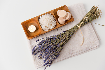 Image showing sea salt, soap, candle and lavender on bath towel